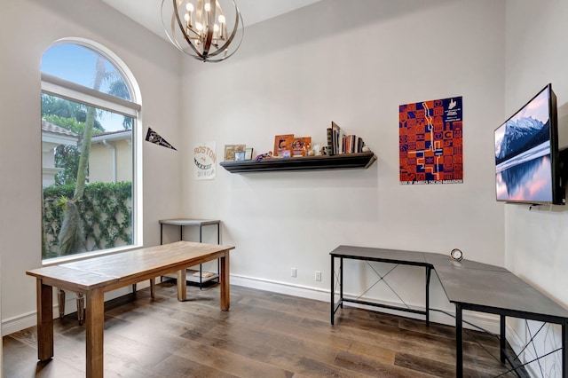 office with hardwood / wood-style floors and an inviting chandelier