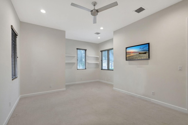 carpeted spare room with ceiling fan