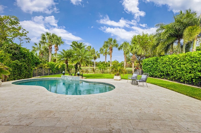 view of swimming pool with a yard and a patio