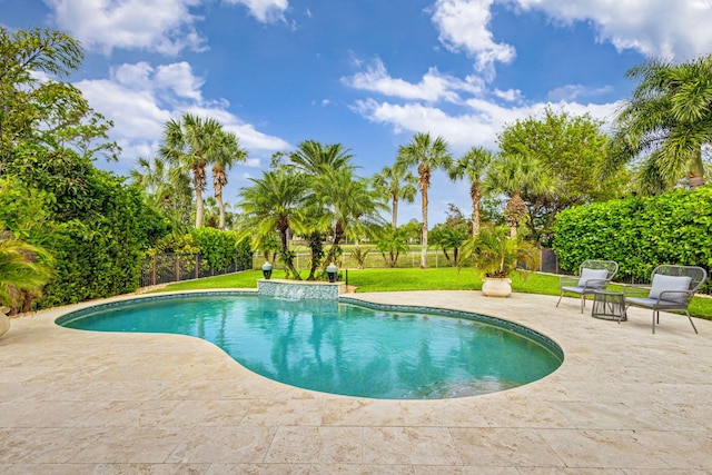 view of swimming pool with a yard and a patio area