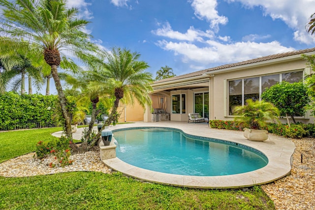 view of swimming pool featuring a lawn and a patio area