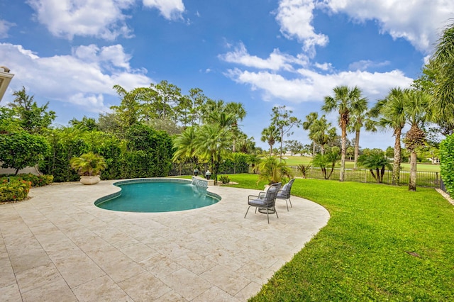 view of swimming pool featuring a lawn, pool water feature, and a patio