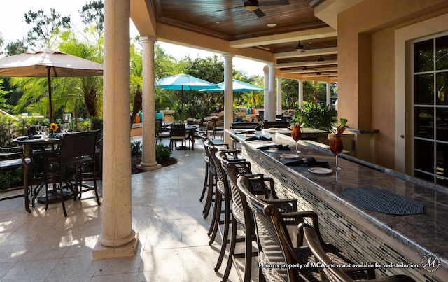 view of patio / terrace featuring ceiling fan and an outdoor bar