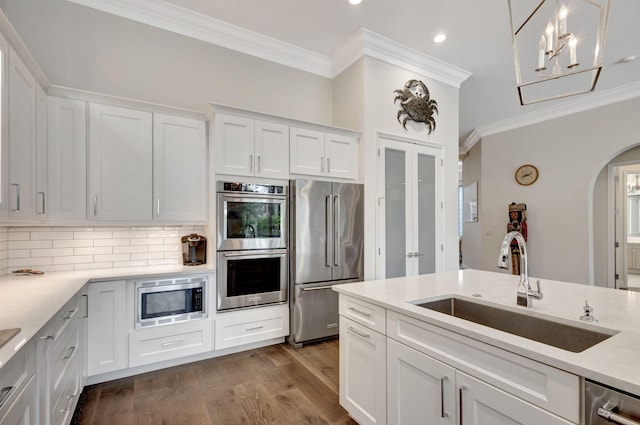 kitchen featuring white cabinets, appliances with stainless steel finishes, and sink