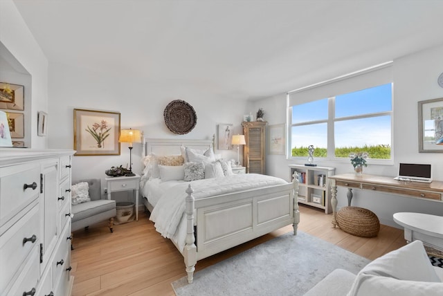 bedroom featuring light wood-type flooring and built in desk