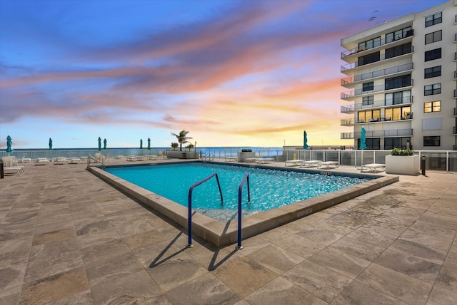 view of pool at dusk