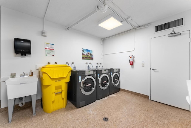 clothes washing area with washer and dryer