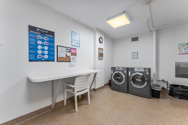 clothes washing area with washing machine and dryer