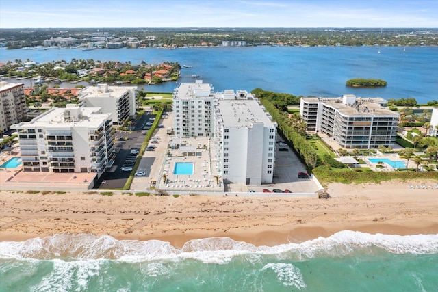 drone / aerial view featuring a beach view and a water view