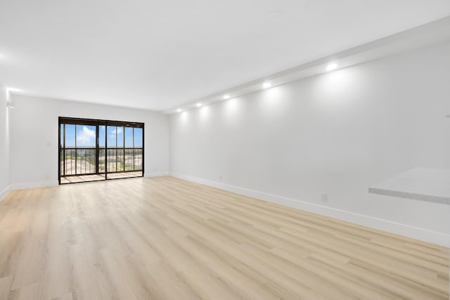 spare room featuring light wood-type flooring