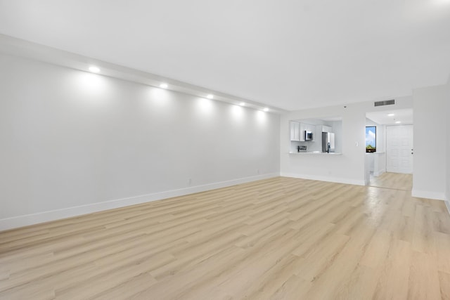 unfurnished living room with light wood-type flooring