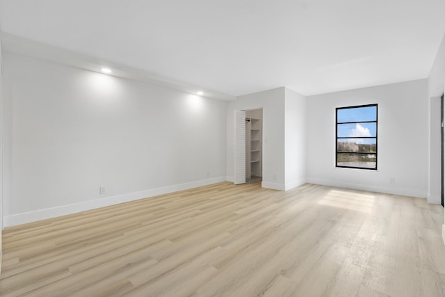 unfurnished room with light hardwood / wood-style floors