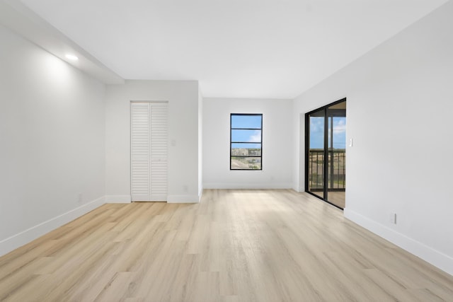 empty room with light hardwood / wood-style flooring