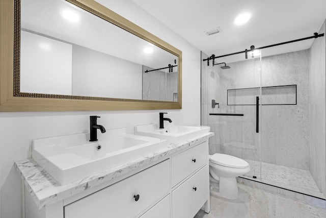 bathroom with a shower with door, vanity, and toilet