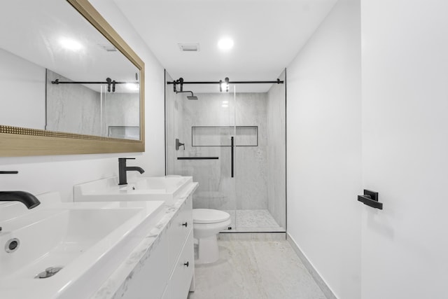 bathroom featuring toilet, vanity, and an enclosed shower