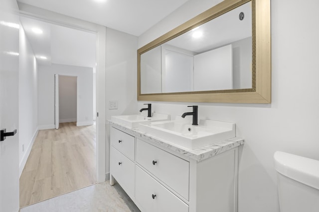 bathroom featuring hardwood / wood-style floors, vanity, and toilet