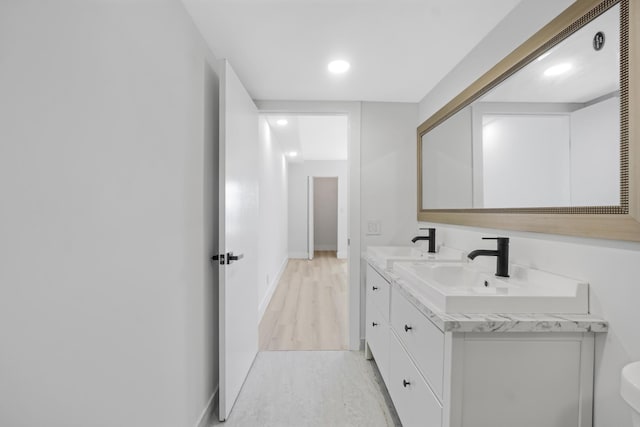 bathroom with hardwood / wood-style floors and vanity