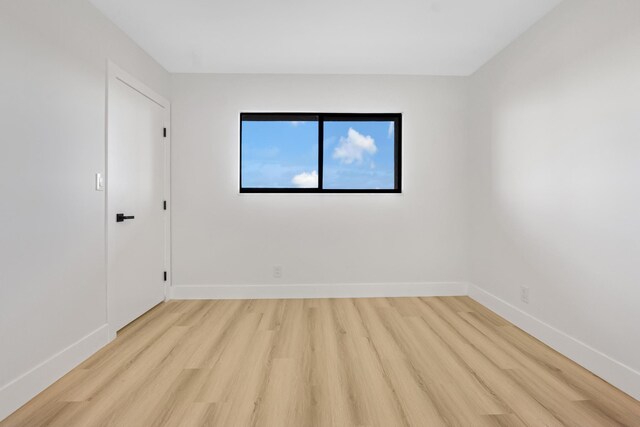 unfurnished room with light wood-type flooring