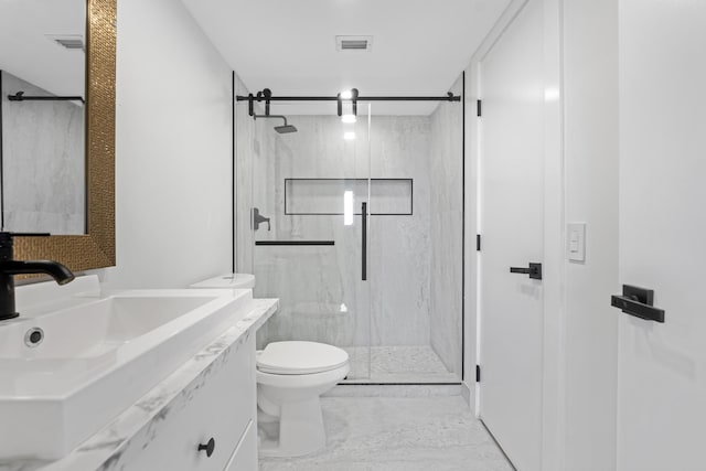 bathroom with an enclosed shower, vanity, and toilet