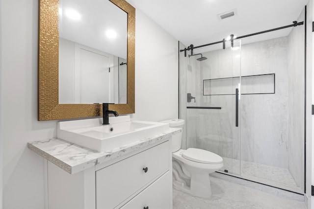 bathroom with toilet, an enclosed shower, and vanity