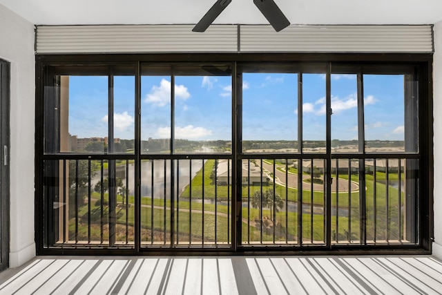 unfurnished sunroom with a healthy amount of sunlight and ceiling fan