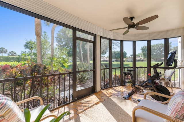 sunroom featuring ceiling fan