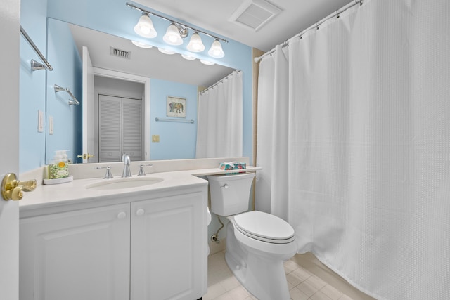 bathroom featuring vanity, toilet, tile patterned floors, and curtained shower