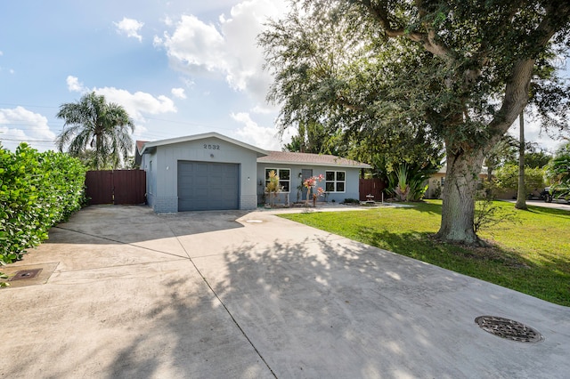 ranch-style home featuring a garage and a front yard