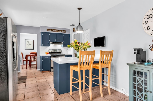 kitchen featuring blue cabinets, hanging light fixtures, tile counters, kitchen peninsula, and stainless steel appliances