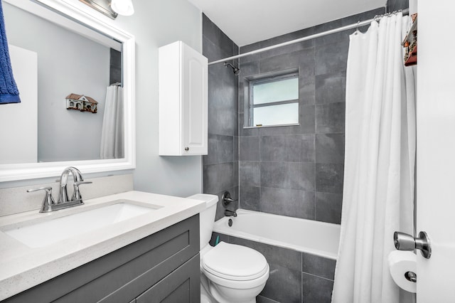 full bathroom featuring vanity, shower / bath combination with curtain, and toilet