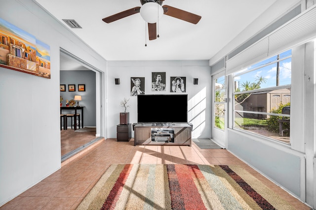 tiled living room with ceiling fan