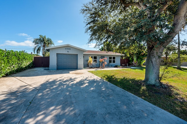 single story home with a front yard and a garage