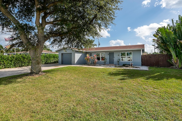 ranch-style home featuring a front yard and a garage