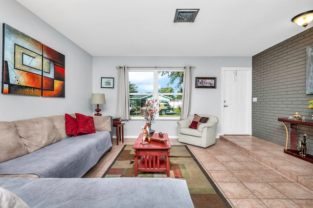 tiled living room with brick wall