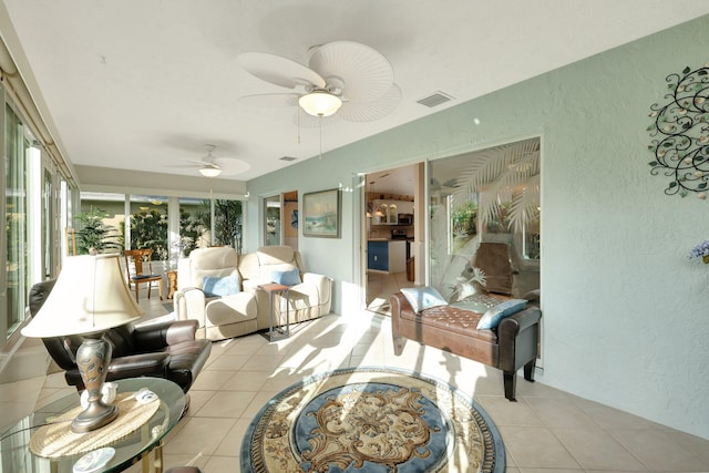 sunroom featuring ceiling fan