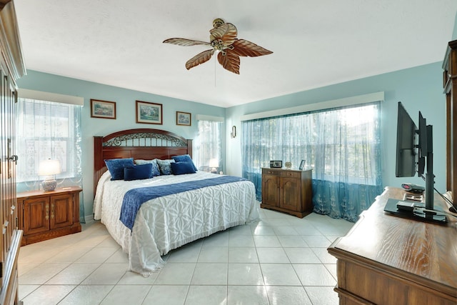 bedroom with ceiling fan and light tile patterned floors