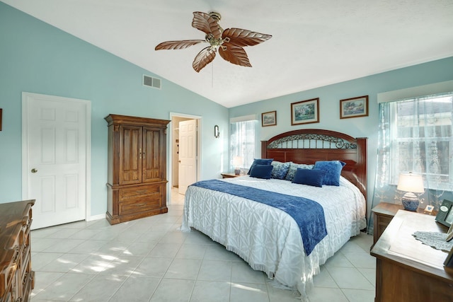 bedroom featuring ceiling fan, light tile patterned floors, and lofted ceiling