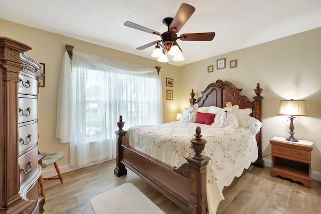 bedroom with ceiling fan and hardwood / wood-style flooring