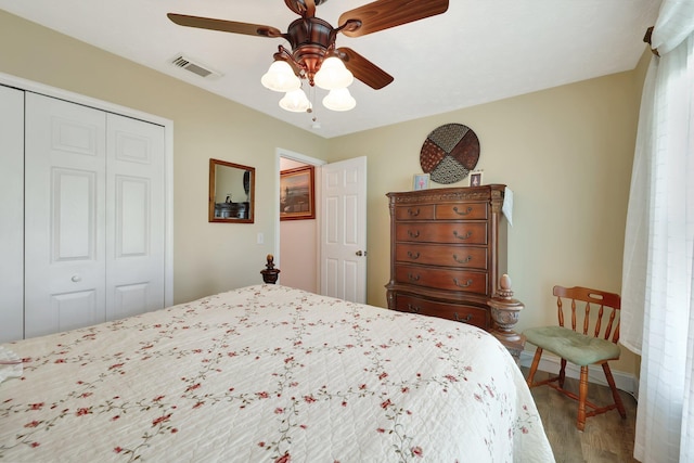 bedroom with ceiling fan, a closet, and light wood-type flooring