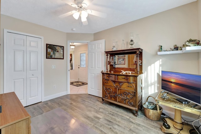 sitting room featuring ceiling fan and light hardwood / wood-style floors