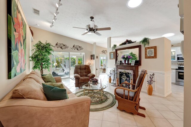 670 Senegal Ct, Fort Pierce, FL 34982 - living area with light tile patterned floors, a ceiling fan, rail lighting, and a textured ceiling