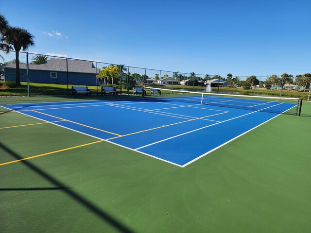 view of tennis court featuring basketball court