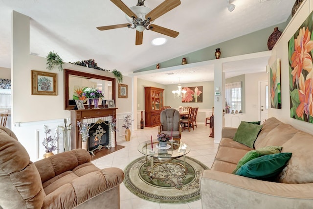 670 Senegal Ct, Fort Pierce, FL 34982 - living room featuring vaulted ceiling, ceiling fan, light tile patterned floors, wainscoting, and a chandelier