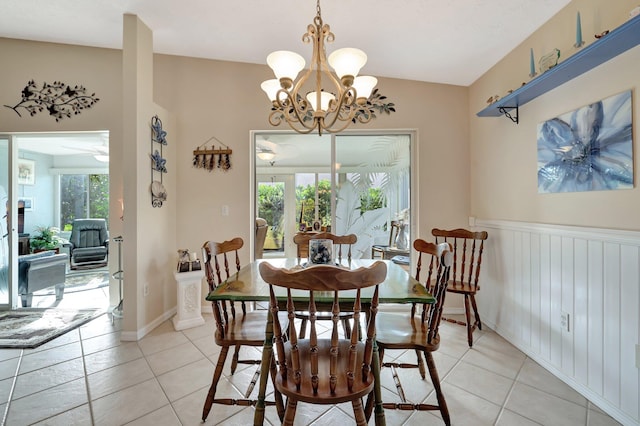 tiled dining space with an inviting chandelier