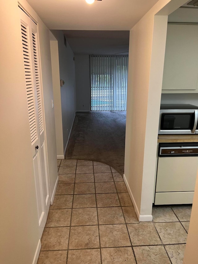 hallway featuring light carpet