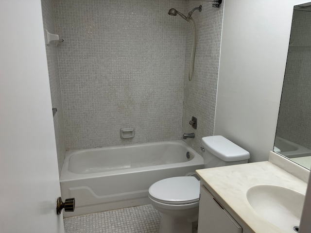 full bathroom featuring vanity, tile patterned floors, toilet, and tiled shower / bath combo