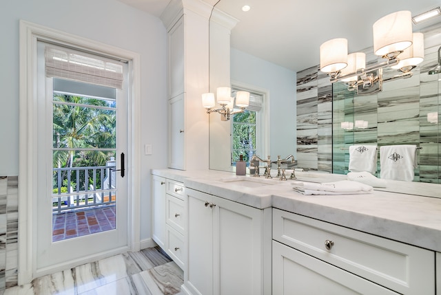 bathroom featuring a chandelier and vanity