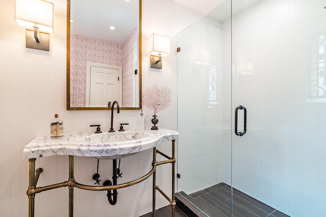 bathroom featuring tile walls and an enclosed shower