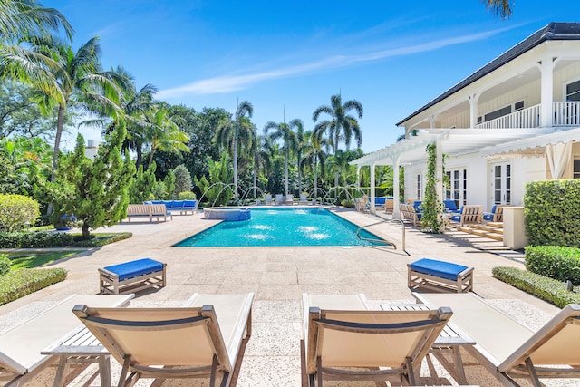 view of swimming pool featuring pool water feature, a pergola, and a patio