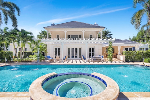 view of swimming pool featuring a pergola, pool water feature, an in ground hot tub, and a patio area